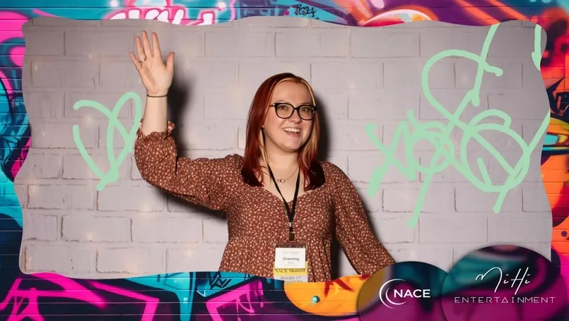Guests using motion-tracking spray cans at graffiti wall photo booth