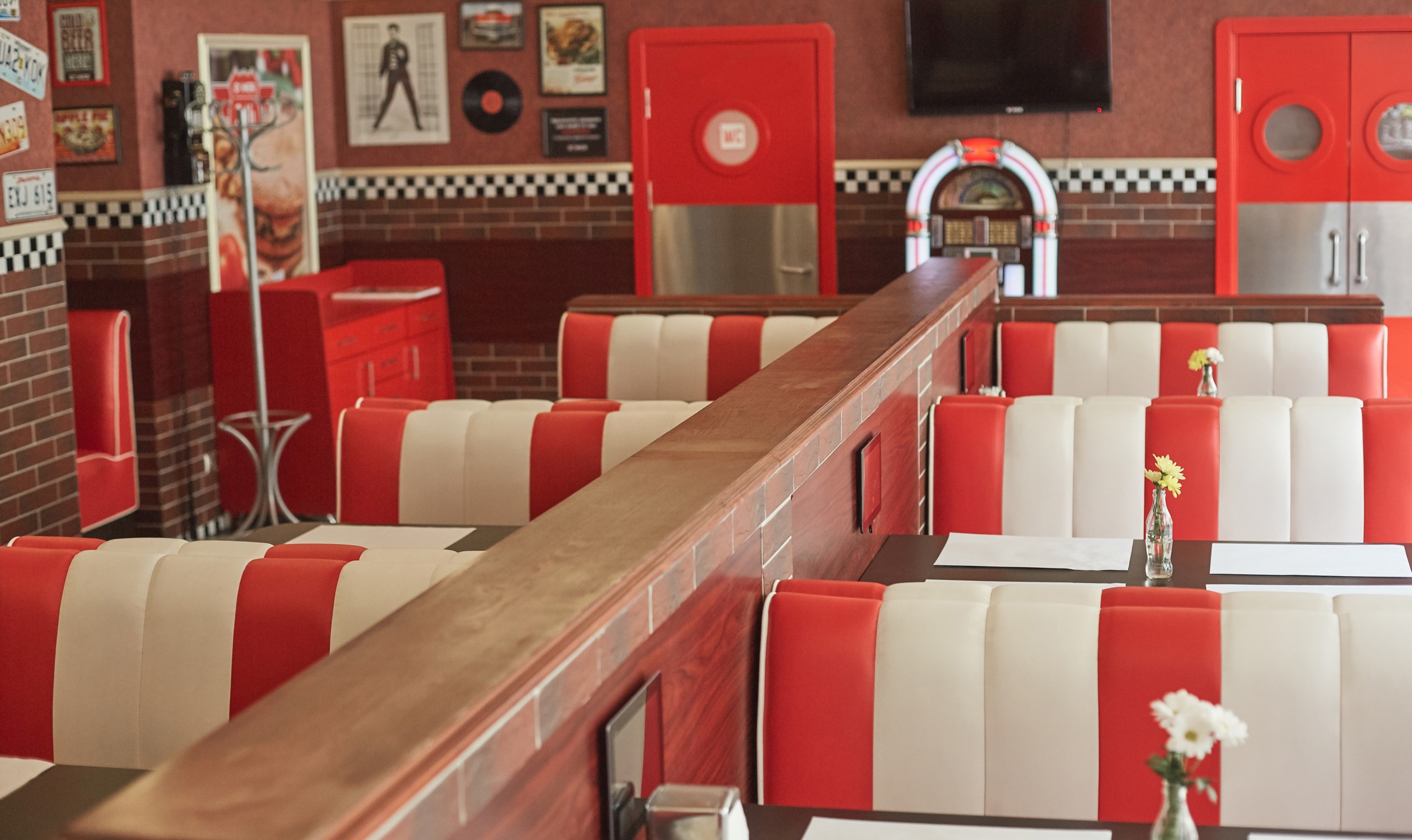Rustic Colorado themed photo booth with people using vintage props