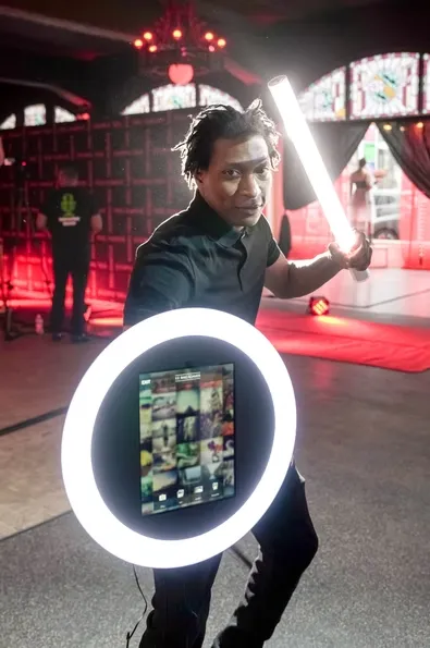 Professional mobile photographer with ring light at wedding event