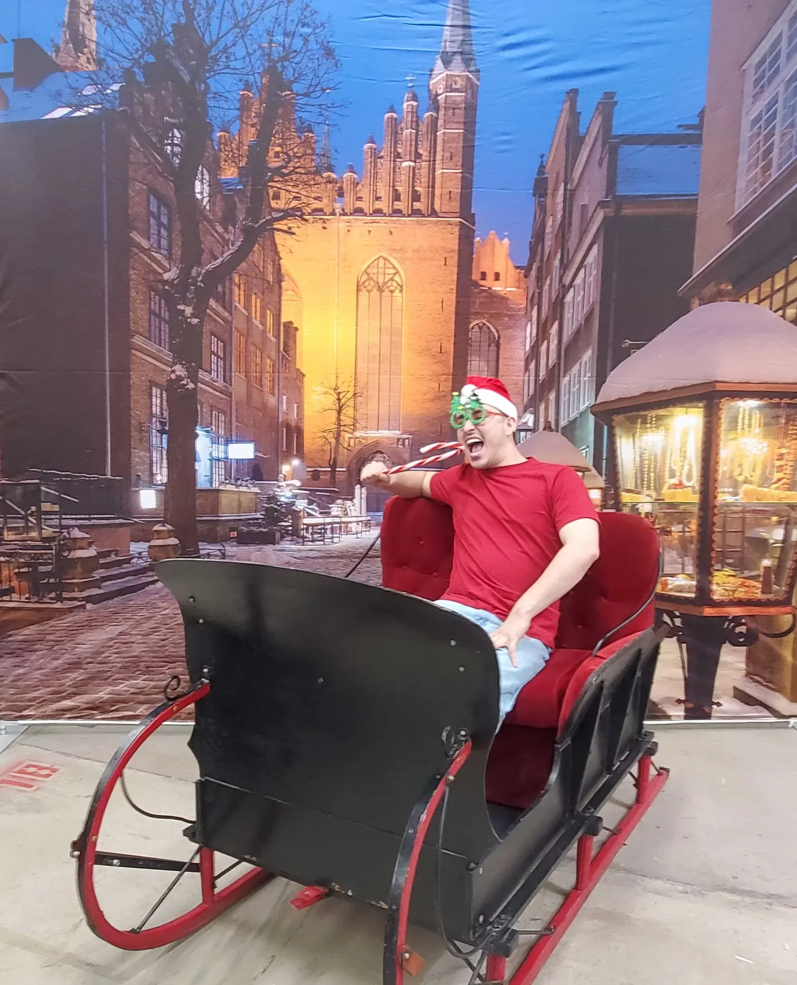 Seasonal photo booth with holiday sleigh, winter props and Victorian backdrop for corporate events